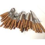 A collection of 1960s/70s teak handled stainless steel flatware including soup spoons, dessert