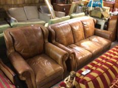 A modern two piece lounge suite comprising a three seater sofa and easy chair in brown hide with