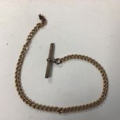 A yellow metal guard link pocket watch chain, unmarked, brass T bar (13.7g) (26cm)