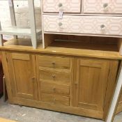 A John Lewis oak side cabinet, the rectangular top above four centre short drawers flanked by