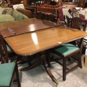 A reproduction mahogany twin pedestal extending dining table, complete with extra leaf (top a/f) (