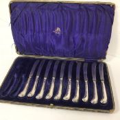 A set of ten silver pistol handled steel bladed side knives, complete with original fitted case (