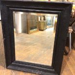 A 19thc ebonised Dutch style rectangular wall mirror with moulded frame and painted black