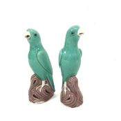 A pair of modern Chinese porcelain parakeet figures mounted on naturalistic base, decorated with