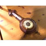 An Edwardian walnut aneroid wall barometer complete with thermometer, with enamelled dial (56cm x