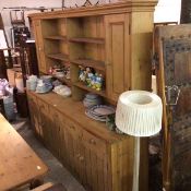 A 19thc style pine kitchen country house dresser, the moulded top above two sets of three open