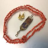 A pair of yellow metal drop earrings, an Egyptian style fob and a pink coral double strand