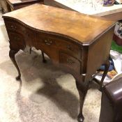 A 1920s walnut serpentine top tallboy style side table, the top with quarter veneered panel and