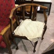 An Edwardian beech corner chair with inset seat raised on carved moulded supports and pad feet (72cm