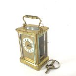 A 19thc four glass brass carriage clock with enamelled dial and arabic numerals, complete with