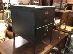 A vintage plywood four drawer filing cabinet, with recessed brass handles on square tapered