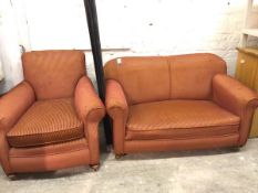 A 1920s two piece lounge suite comprising an upholstered easy chair and two seater drop end sofa