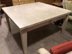 A bleached pine square top kitchen table, fitted frieze drawer to each side, raised on square