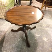 A mahogany low pedestal table with scalloped top on turned column and tripod support (40cm x d.