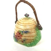 A Royal Winton Grimwades beehive biscuit barrel, the top with floral knop and original raffia