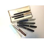 A collection of vintage pens including three various Parker fountain pens, one with gold plated top,