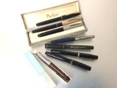 A collection of vintage pens including three various Parker fountain pens, one with gold plated top,