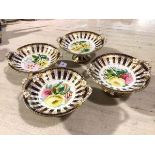 A set of four 19thc dessert service comports decorated with handpainted floral sprays, enclosed