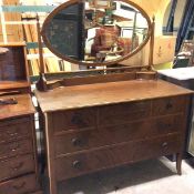 An Edwardian mahogany dressing chest, the oval mirror above a pierced gallery fitted two centre