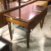 A reproduction mahogany pembroke table, the rectangular top with twin drop flaps and plain frieze,