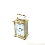 A Shortland Bowen English four glass miniature clock with enamelled dial and roman numerals,