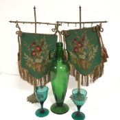 A pair of Edwardian brass fireplace penants, with hand sewn tapestry panels, with tassels, on cast