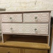 A pine miniature chest with painted lattice effect, fitted two short and one long drawer (61cm x