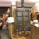 An oak spiral twist column floor lamp raised on circular moulded base and an oak fluted tapered