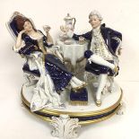 A Royal Dux china figure group, Tea Time, a group of 18thc style dressed figures, recumbent