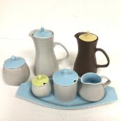 A Poole pottery set c.1960 including two hot milk jugs, a sugar basin, a jam pot, a miniature