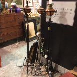 Two wrought iron and brass mounted and copper Art Nouveau style adjustable column oil lamps,