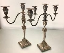 A pair of silver plate on copper candelsticks in the Adam taste, possibly c. 1800, each with