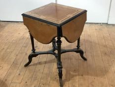 An unusual amboyna and boxwood-lined games table, c. 1880, the quatrefoil top with revolving centre,