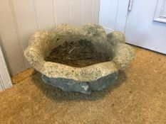 A weathered composition stone garden planter, lobed and of flowerhead form. 19cm by 41cm