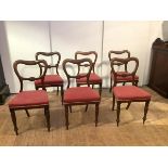 A set of six mid-19th century solid rosewood dining chairs, each with undulating top rail and curved