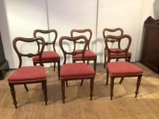 A set of six mid-19th century solid rosewood dining chairs, each with undulating top rail and curved