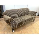 A Victorian mahogany sofa, the shaped back and outswept arms upholstered in striped fabric, on