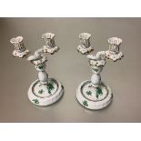 A pair of Herend porcelain twin-branch candelabra in the green Chinese Bouquet or Apponyi pattern.