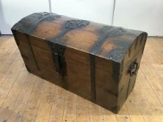 A 19th century Continental oak and iron-bound trunk, the domed lid with pierced iron strapwork above