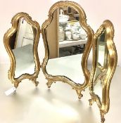 An Italian giltwood triptych dressing table mirror, each cartouche-shaped plate within a