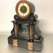 A 19th century black slate and red marble drumhead mantel clock, of architectural form, the two