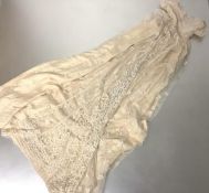 An early/mid-19th century embroidered and applique whitework christening gown, lace trimmed on net
