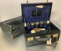 A 1930's leather lady's dressing case, partially fitted with five silver-topped glass scent and