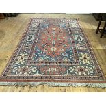 A small hand-knotted Heriz carpet, the terracotta field decorated with stylised flowers and