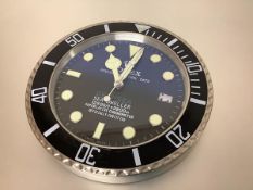 A Rolex advertising wall clock, "Deep Sea Sea-Dweller", battery operated. Diameter 34cm