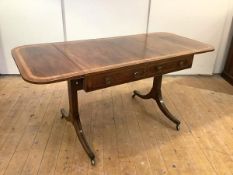 A Regency rosewood sofa table, c. 1810, the rectangular top with satinwood crossbanding and twin