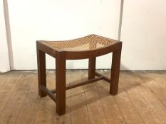 Cotswold School: a teak-framed stool, mid-20th century, the concave seat inset with woven cane, on