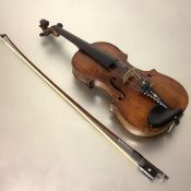 A 19th century violin, probably German, of caramel colour, the one piece back measuring 35.5cm, (