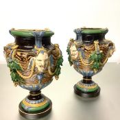 A pair of Minton majolica "Bacchus" vases, of baluster form, each applied with three satyr masks and