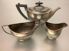 A late Victorian silver bachelor's three-piece tea service, George Edwards & Son, Sheffield 1900, in